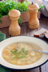 Transparent potato soup in meat broth, selective focus