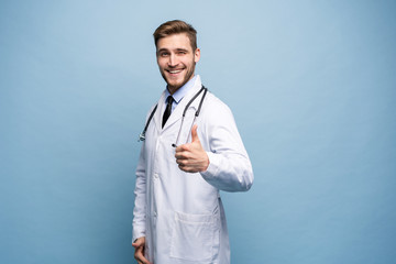 Portrait of a friendly doctor smiling giving thumbs up.