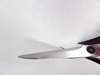 Sharp scissors cutting paper