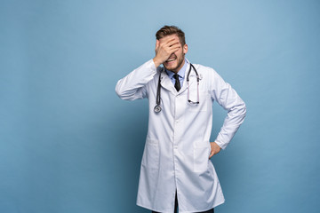 Doctor young man, medical professional terrified and nervous expressing anxiety and panic gesture,...
