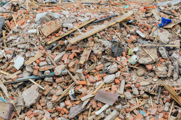 Construction debris from the dismantled building. Fragments of broken bricks, fragments of boards...