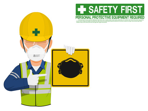 A worker with dust mask is presenting dust mask sign