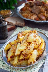 Sliced roasted mustard potatoes with grains, selective focus