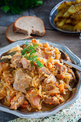 Cabbage stew with turkey meat in a metal dish, selective focus