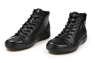 Men's black leather shoes and a black camera on a isolated on white background. Copy space.