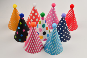 Colorful birthday caps on a white background.