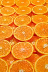 Slices of oranges as a background, top view.