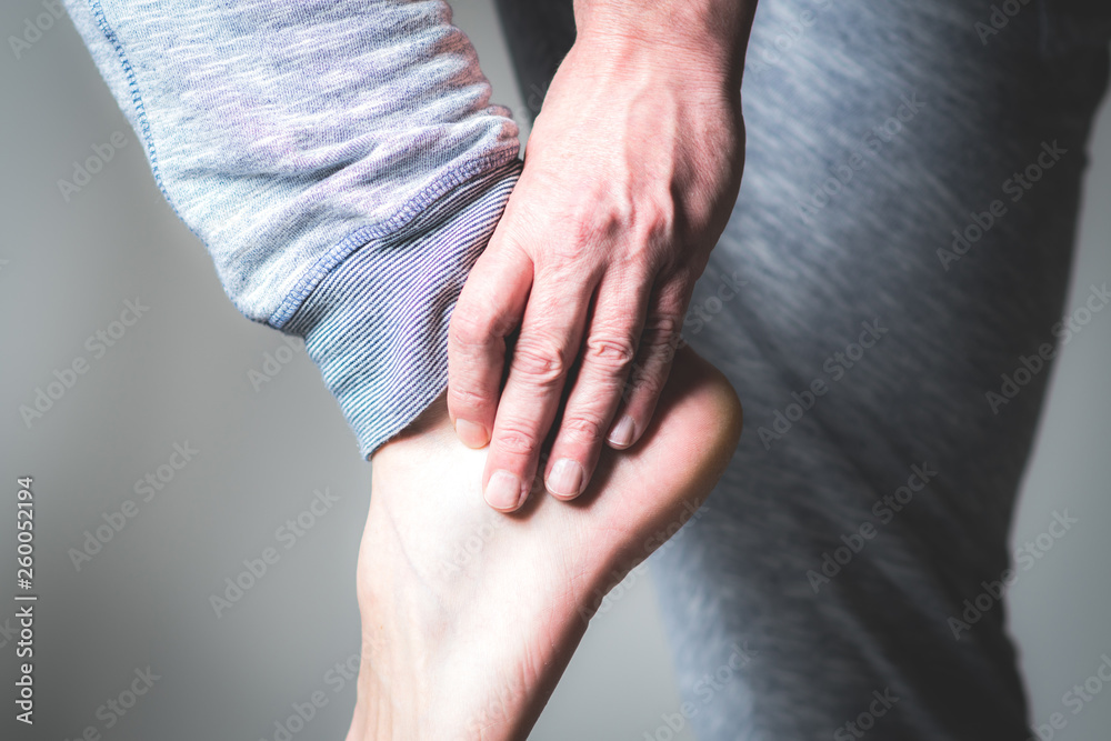 Wall mural man with pain in foot