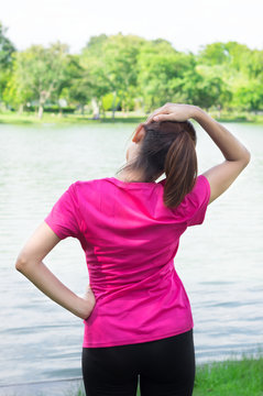 Woman stretching her neck to warm up.