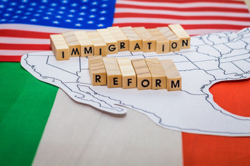 Immigration Reform concept on US-Mexico border with United States and Mexico flags