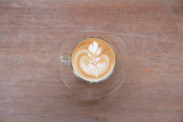 Coffee cup with latte art foam on wood table in coffee shop with copy space.Coffee is one of the most popular beverages.Improve Energy Levels and Burn Fat