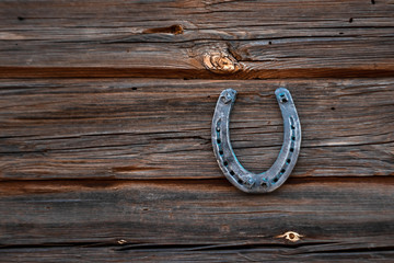 Old horseshoe on an old wooden board. The concept of luck, luck, luck.