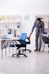 Leg injured male employee working in the office 