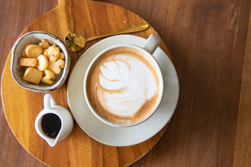 Coffee cup with latte art foam on wood table in coffee shop with copy space.Coffee is one of the most popular beverages.Improve Energy Levels and Burn Fat