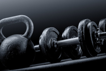 Weights and dumbbells on a black background