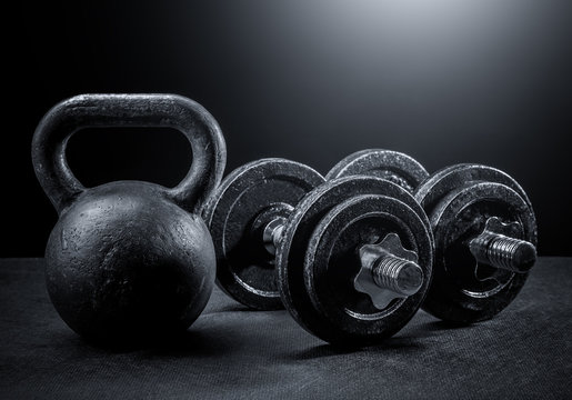Weights and dumbbells on a black background