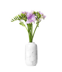 Bouquet of fresh freesia flowers in vase isolated on white