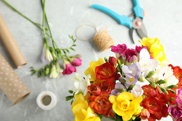Flat lay composition with freesia flowers on table