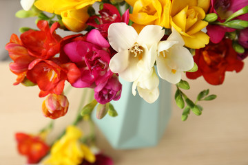Beautiful spring freesia flowers on table, closeup