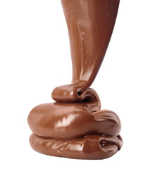 Pouring sweet chocolate cream on white background