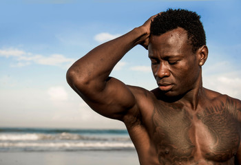 portrait of young attractive and fit black afro American man with strong muscular body posing cool...