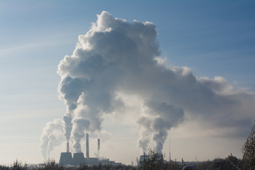 smoke from chimney on background of blue sky