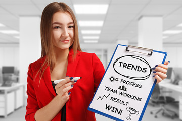 Business, technology, internet and networking concept. Young entrepreneur showing keyword: Trends