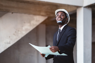 African engineer man stand up and looking upper with thinking