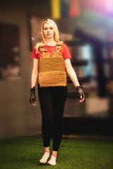 young blonde woman with boxing belts in her hands looking determined strong and sharp wearing light...