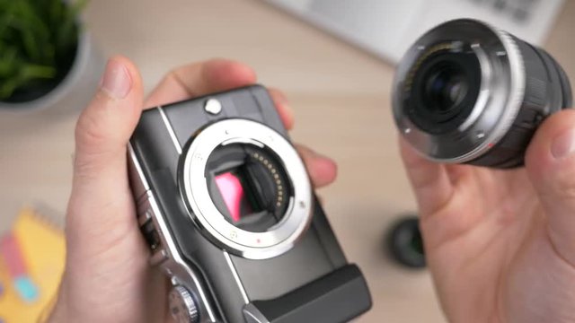 Changing the lens on an interchangeable lens camera. Top view