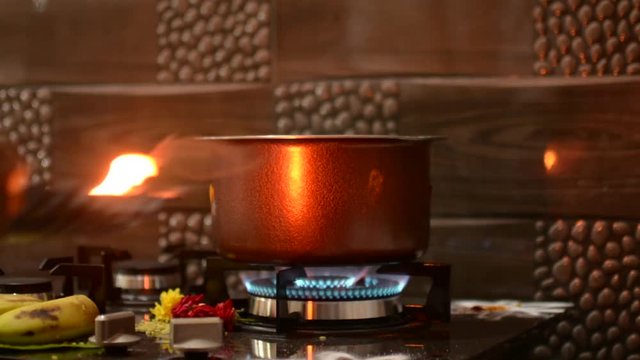 Detail of the Boiling the Milk for the Indian Traditional House Warming ritual. Flat plane. Eye level shot. Zoom in