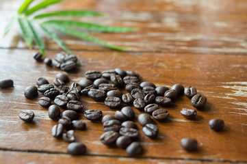 Black coffee beans on table.