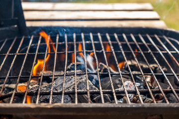 Grill charcoal burning with an open flame isolated 