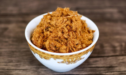 Rousong or beef floss on wood background.