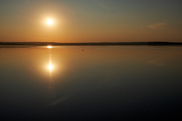 Sunset on the lake without waves