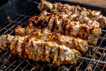Traditional shashlik cooking on a grill isolated