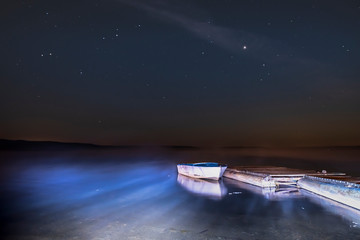 Fishing boat on the pier at night