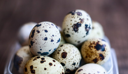 Quail Eggs on wood background. Quail eggs also help to improve metabolism, reduce blood pressure, improve allergy symptoms, and prevent chronic diseases.