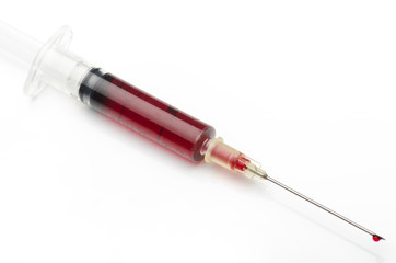 Fototapeta premium syringe with a red fluid on white background