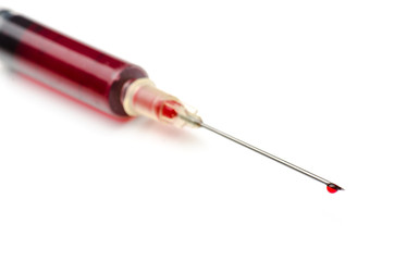 Fototapeta premium syringe with a red fluid on white background