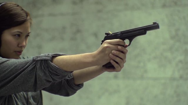 Slow Motion - Asian Girl Aiming Gun