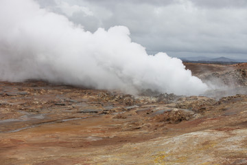 Iceland geothermal zone - area in mountains with hot springs. Cracks in mountains with hot steam.Tourist and natural attractions.