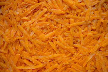 grated fresh carrot for background or texture, raw ingredient for salads