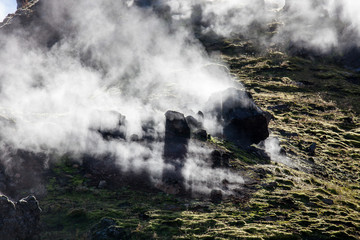 Iceland geothermal zone - area in mountains with hot springs. Cracks in mountains with hot steam.Tourist and natural attractions.