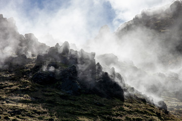 Iceland geothermal zone - area in mountains with hot springs. Cracks in mountains with hot steam.Tourist and natural attractions.