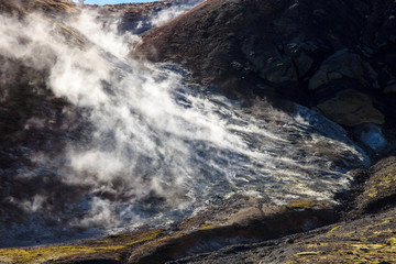Iceland geothermal zone - area in mountains with hot springs. Cracks in mountains with hot steam.Tourist and natural attractions.