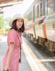 Hipster young traveler waiting train at station,