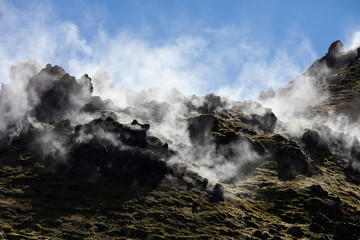 Iceland geothermal zone - area in mountains with hot springs. Cracks in mountains with hot steam.Tourist and natural attractions.
