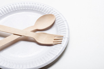 Wooden single use kitchenware and paper plate on white background