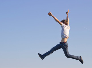 teenager in white t-shirt bouncing high up